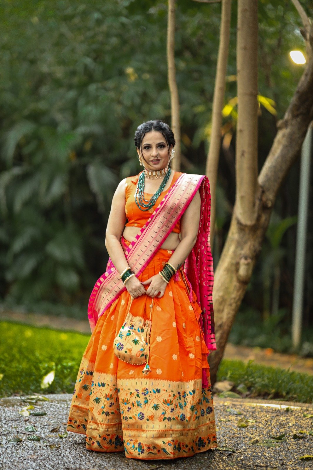 ORANGE RED TIE AND DYE BUTI WORK LEHENGA SET WITH A HAND EMBROIDERED CUT  OUT BLOUSE PAIRED WITH A MATCHING DUPATTA AND MIRROR WORK DETAILS. -  Seasons India