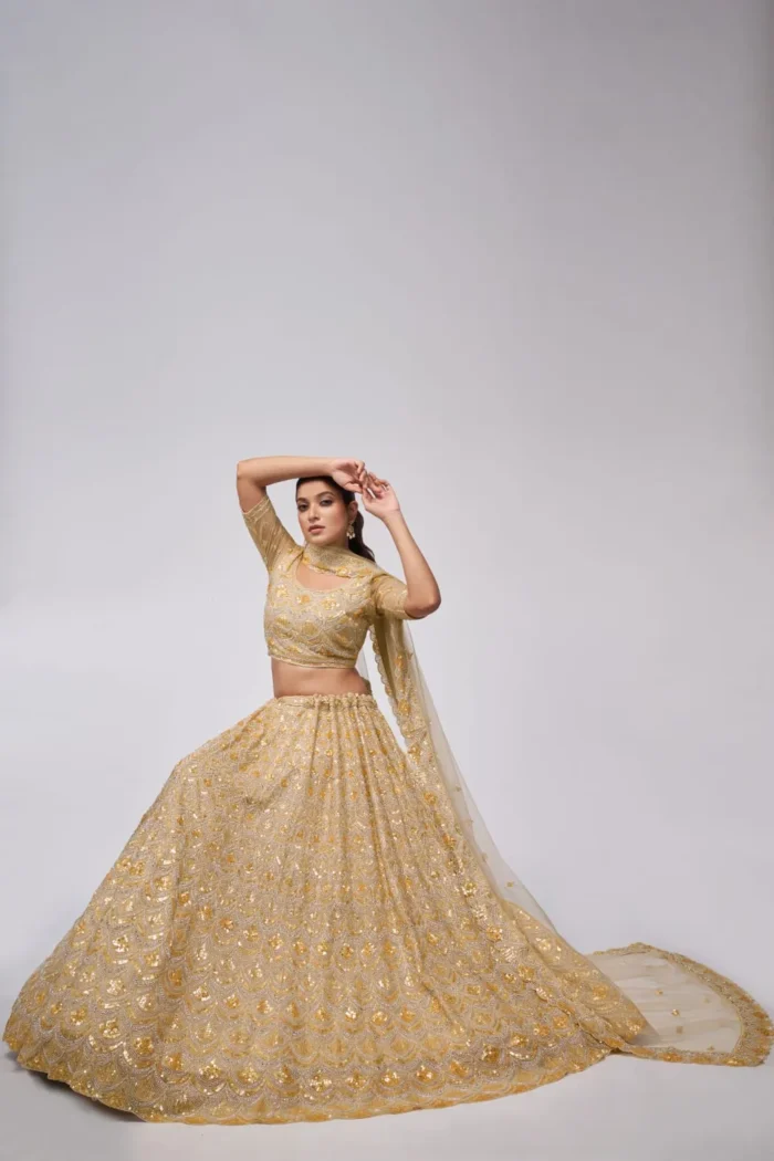 golden color leaves pattern sequins embroidered soft net bridal lehenga choli