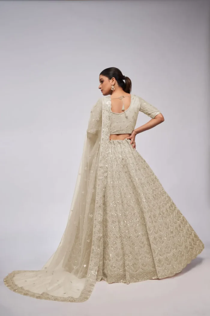 white ivory color leaves pattern sequins embroidered soft net bridal lehenga choli