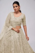 white ivory color leaves pattern sequins embroidered soft net bridal lehenga choli