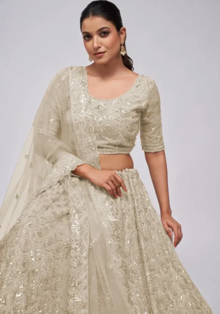 white ivory color leaves pattern sequins embroidered soft net bridal lehenga choli