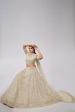 white ivory color leaves pattern sequins embroidered soft net bridal lehenga choli