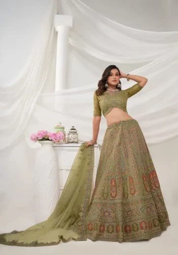 Green color lehenga with intricate paisley floral motifs embedded with shimmering rhinestones and zari work with soft net fabric bridal lehenga choli