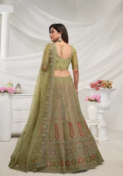 Green color lehenga with intricate paisley floral motifs embedded with shimmering rhinestones and zari work with soft net fabric bridal lehenga choli