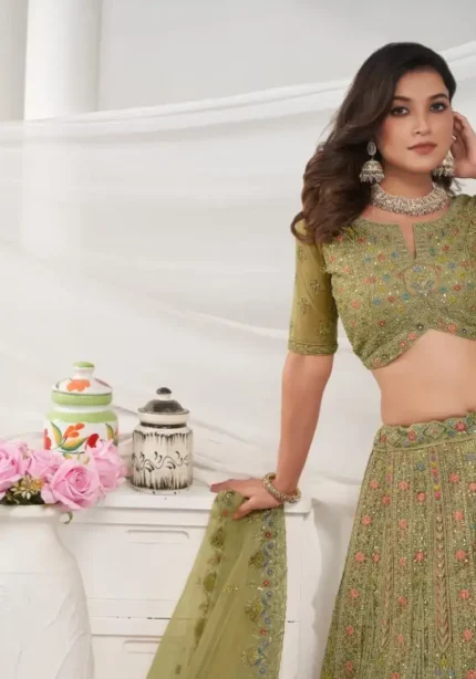 Green color lehenga with intricate paisley floral motifs embedded with shimmering rhinestones and zari work with soft net fabric bridal lehenga choli