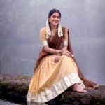 Village girl wearing Cream Colour Kanchipuram Half Saree Lehenga on riverside