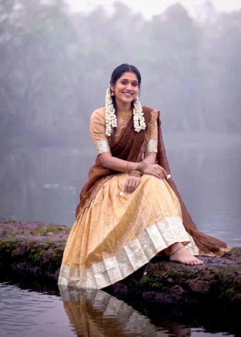 Village girl wearing Cream Colour Kanchipuram Half Saree Lehenga on riverside