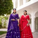 Two girls wearing Purple and Red Colour Pure Chanderi Bandhej Navratri Lehenga