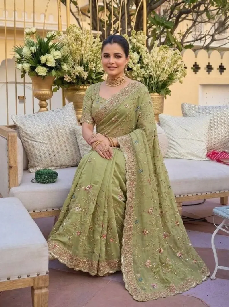 Elegant Green Star Georgette Embroidered Party Wear Saree sitting pose