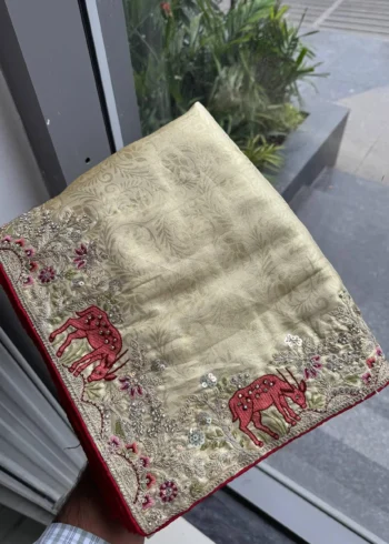 Beige Kanjivaram Silk Heavy Embroidered Wedding Saree in hand