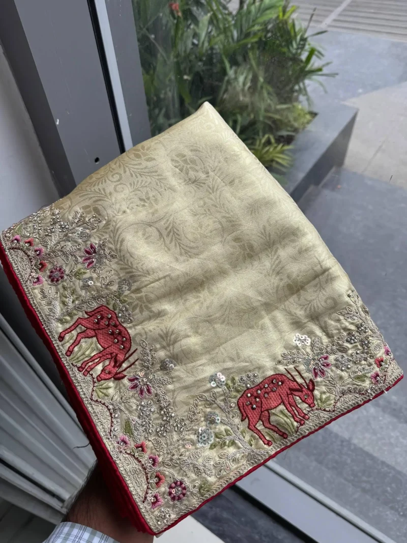 Beige Kanjivaram Silk Heavy Embroidered Wedding Saree in hand
