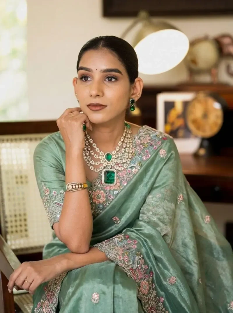 Teal Pure Soft Tissue Silk Party Wear Saree close sitting pose