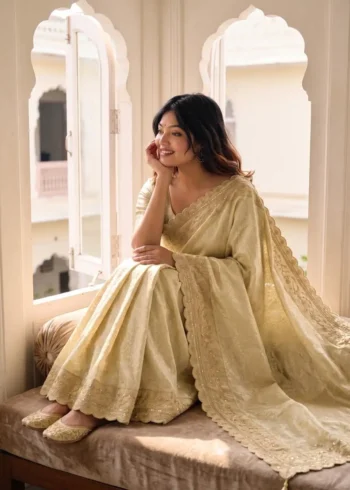 Pastel Cream Pure Kanjivaram Silk Wedding Saree with Gold Zari Weaving Border sitting pose