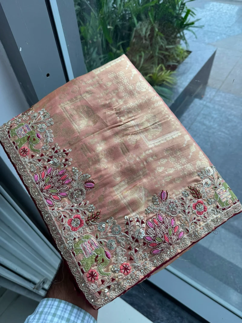 Peach Royal Hathi Pure Kanjivaram Silk Heavy Embroidered Bridal Saree in hand